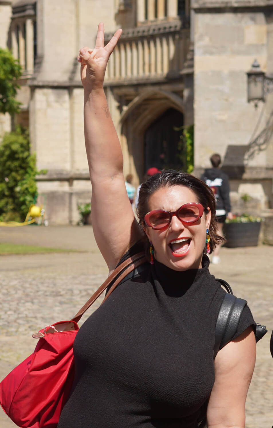 Happy employee pointing to sky