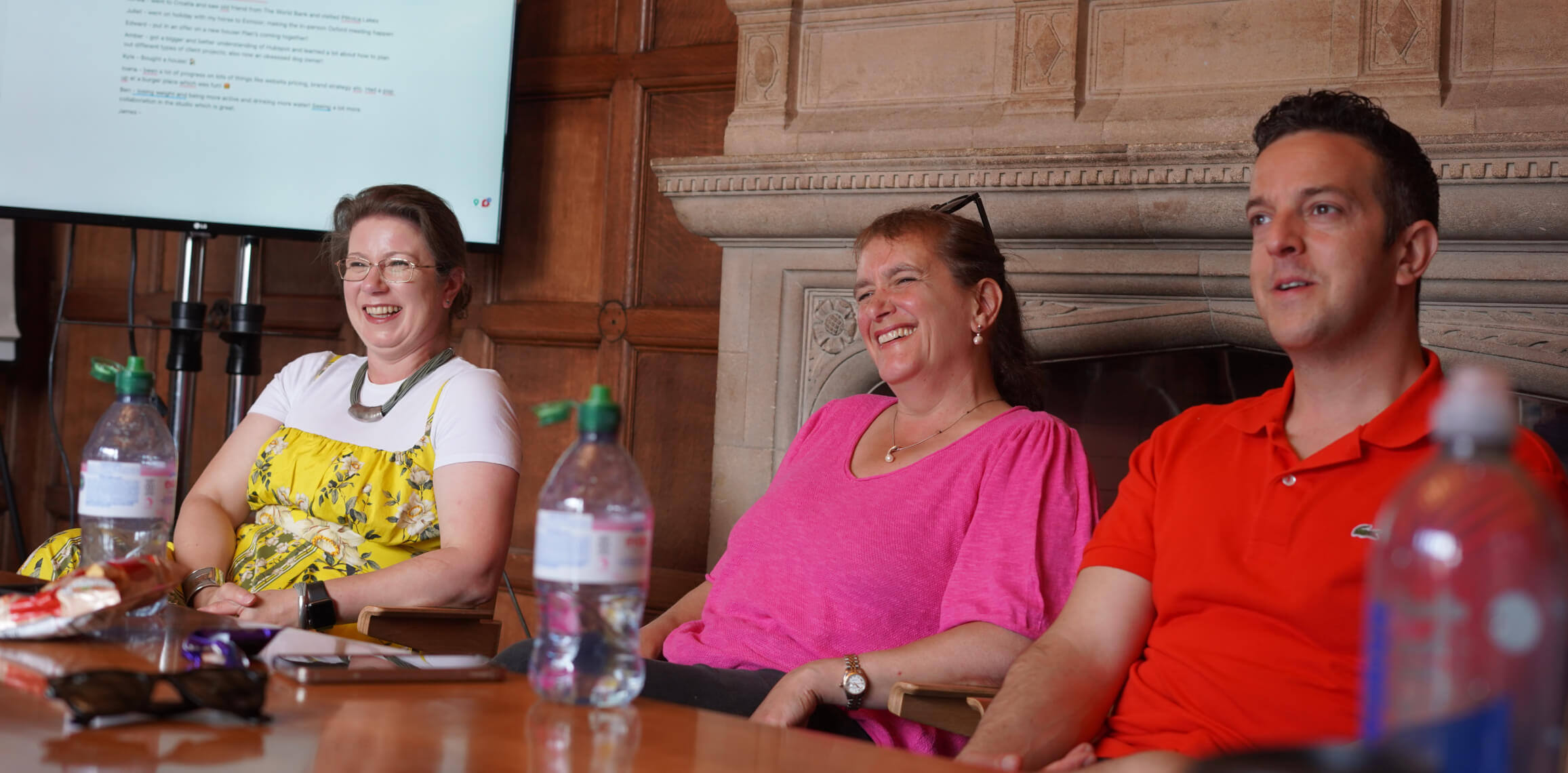 Three employees laughing together