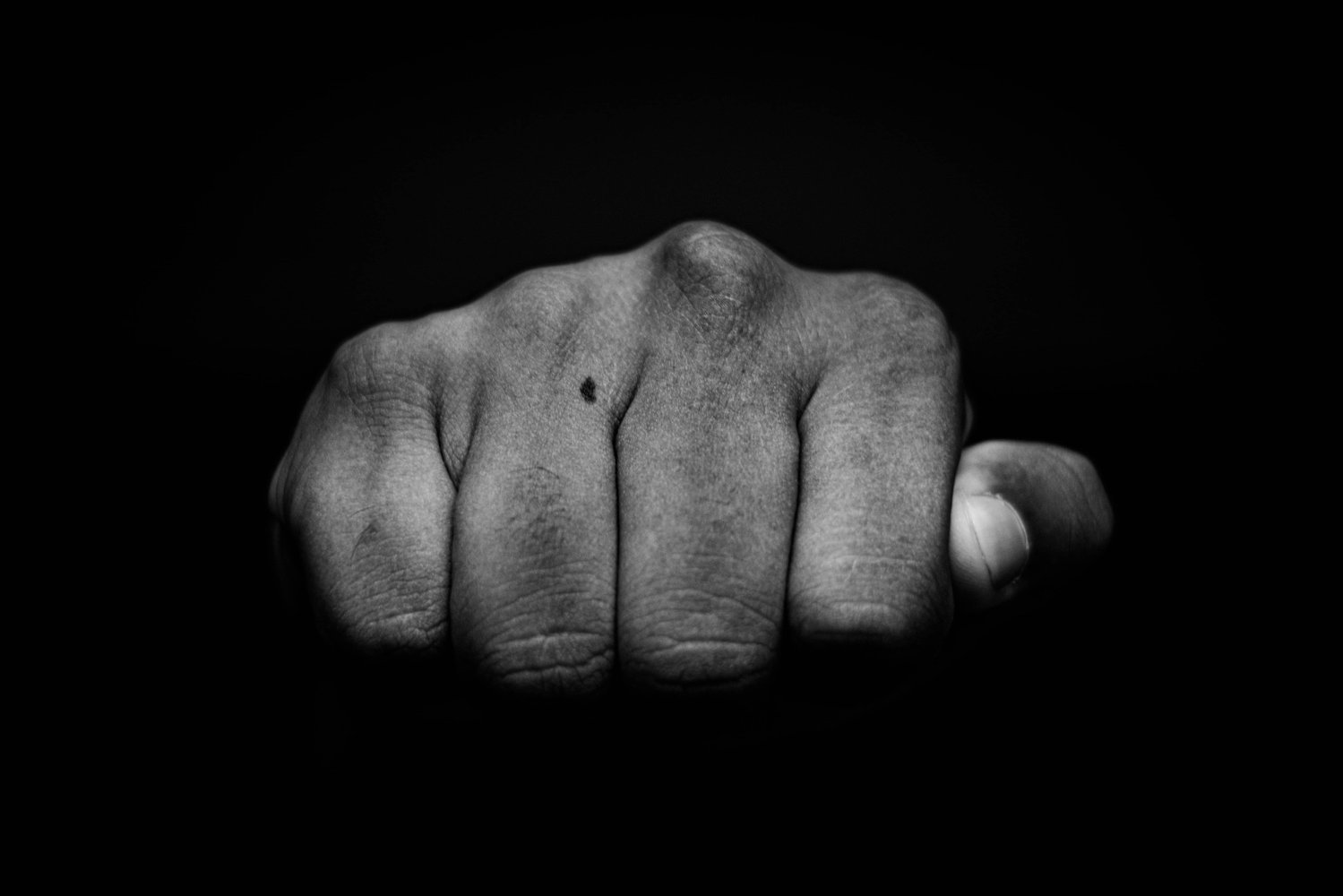 High contrast image of a fist to illustrate a 'punchy' lede in writing