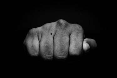 High contrast image of a fist to illustrate a 'punchy' lede in writing