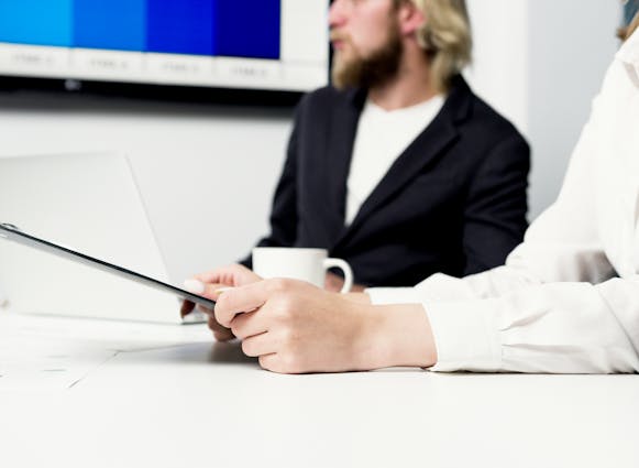 A person sitting in a meeting within an office