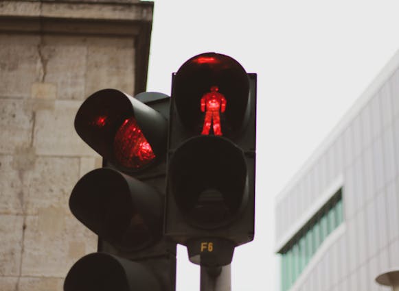 A red pedestrian light and red traffic light